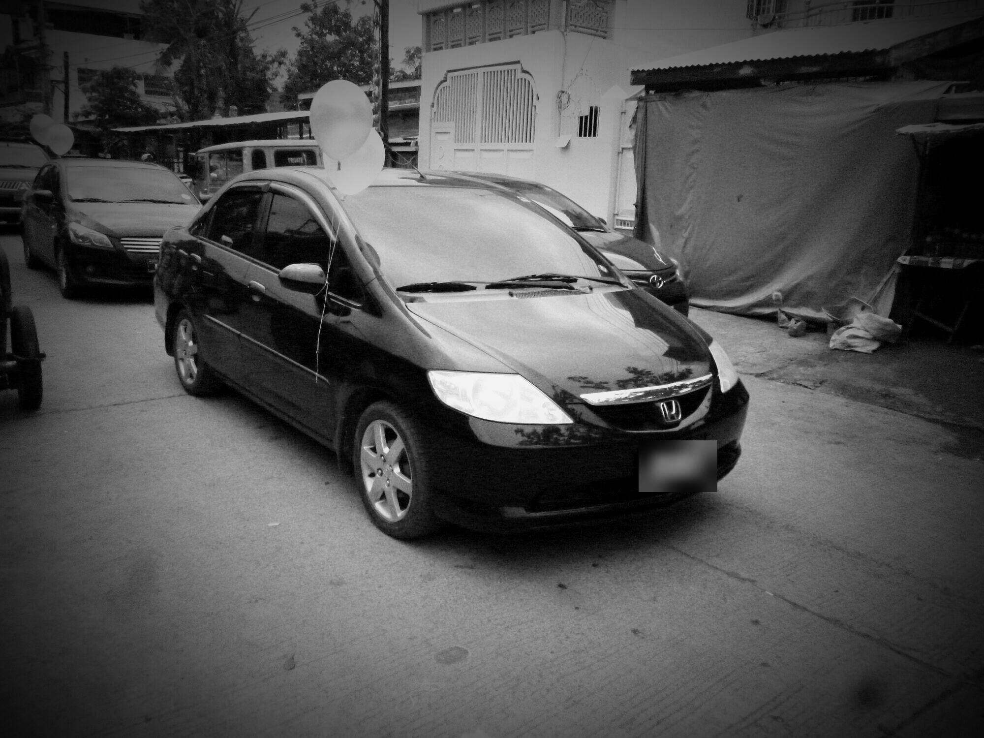 A black 2005 Honda City sedan
