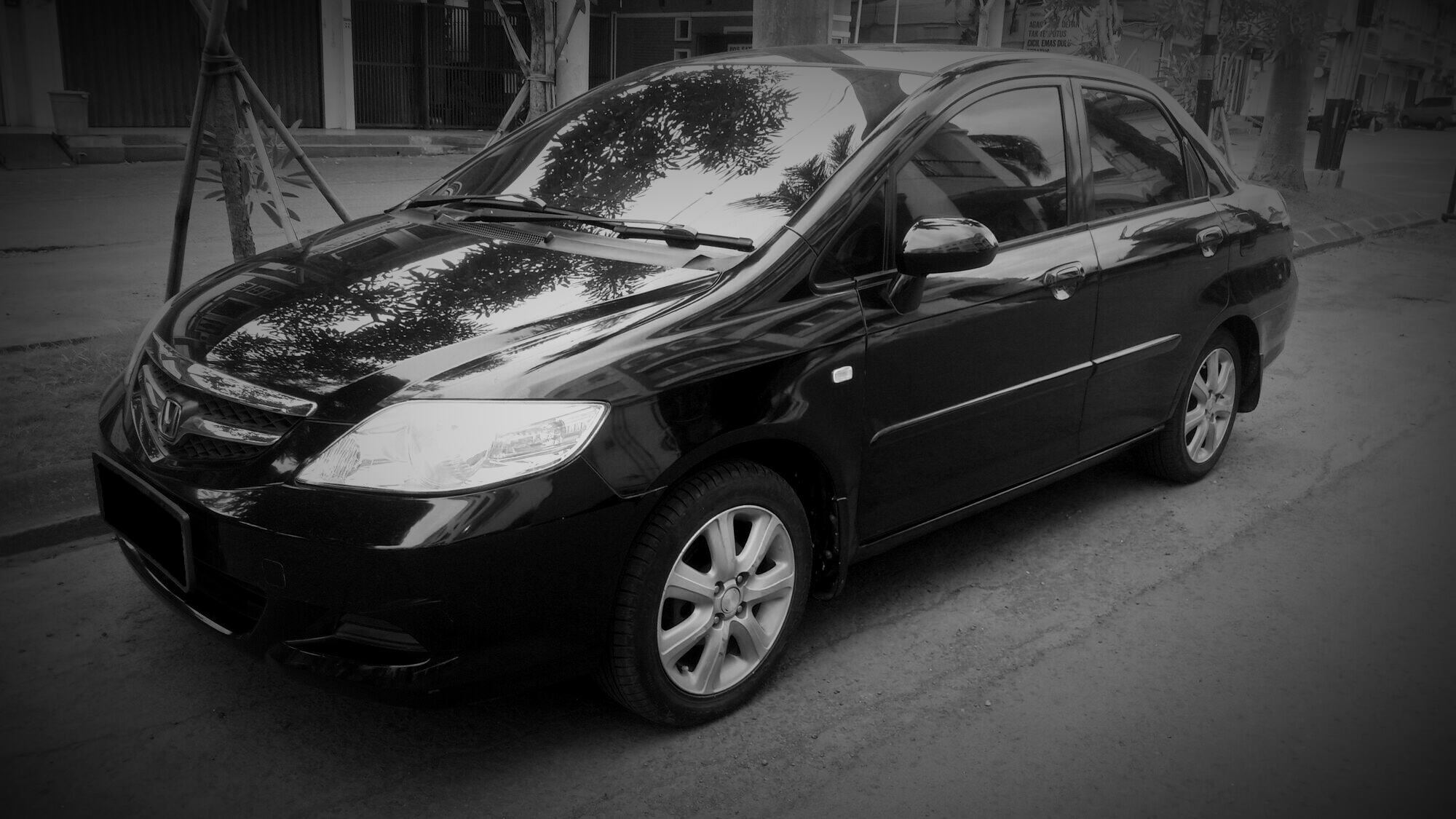 A black 2006 Honda City sedan